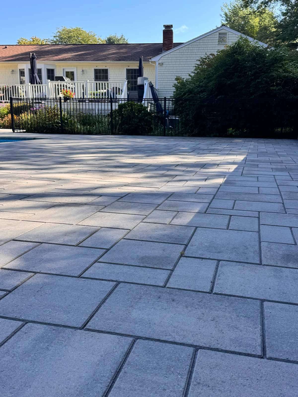Freshly sealed paver pool patio shown from a second angle